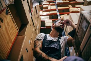 worker tired by boxes