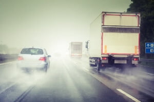 photo illustration of cars on rainy road