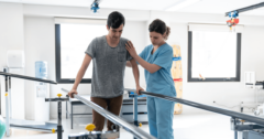 assisting patient with walking at rehab facility