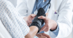 doctor examining wrist brace