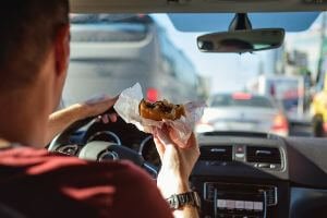 eating a cheeseburger behind the wheel