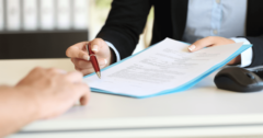 pointing at signature line on contract