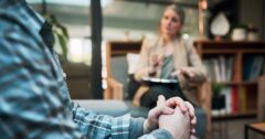 man sitting on couch in therapist's office