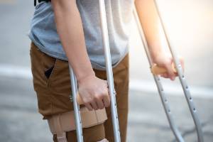 person outside on crutches