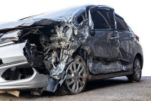 severely damaged car on road