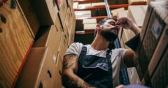 worker tired by boxes