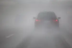 back of a car driving through thick fog